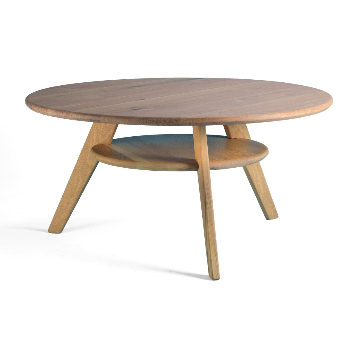 First Light round coffee table in solid oak, Light Roast, three-quarter view