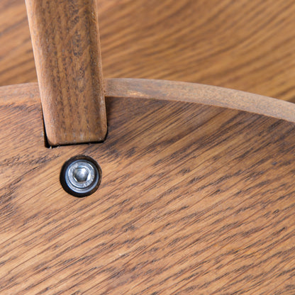 First Light detail: a leg seated in the shelf beside the bolt that holds it